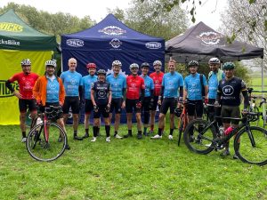 Tour de BT riders gathered in front of gazebos at a rest stop